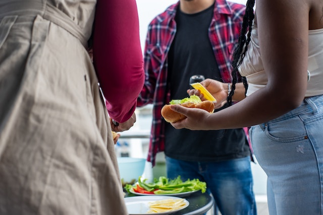 Coworkers enjoying food at a picnic.