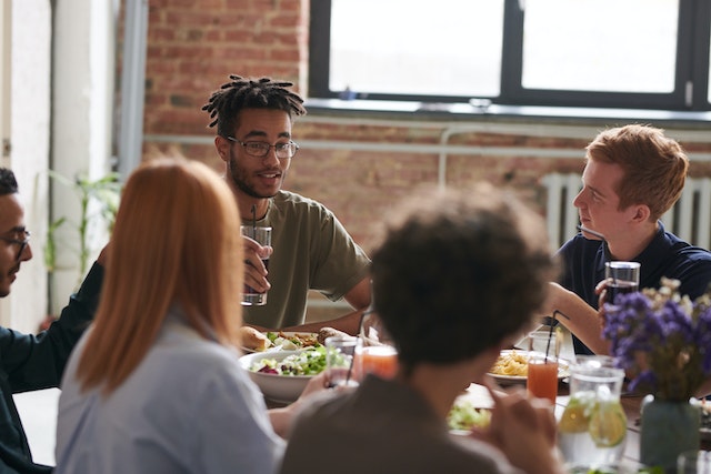 People talking and eating food.