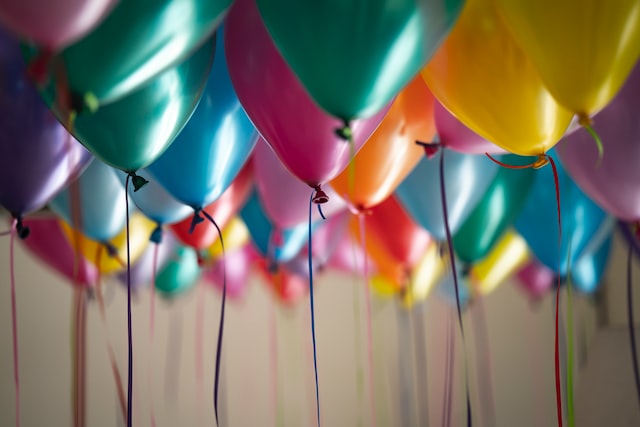 lots of balloons of different colors on the ceiling