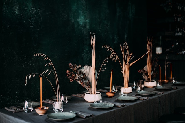 A banquet table in a stylish restaurant with dark wallpaper