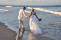 https://www.pexels.com/photo/man-and-woman-in-wedding-dress-walking-on-beach-4119625/