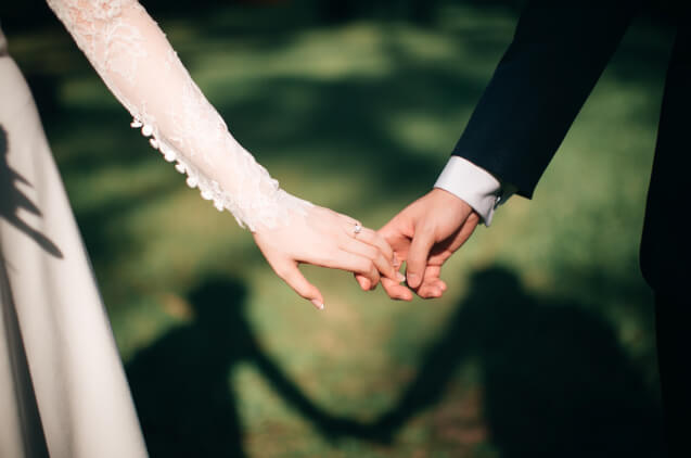 The bride and groom holding hands