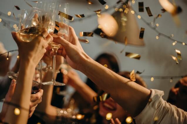 People tasting with wine glasses portraying a successful event party checklist.