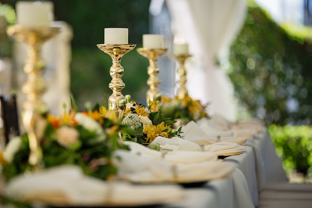 A wedding table with plates and candles